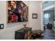 Stylish hallway features unique artwork, a decorative dresser, and a zebra-print stool, leading to a brightly lit bedroom at 4978 Fawn Ridge Pl, Sanford, FL 32771