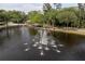 Scenic pond with a decorative fountain surrounded by lush trees at 4978 Fawn Ridge Pl, Sanford, FL 32771