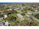 Aerial view of a home with well-manicured lawn, mature trees, and proximity to a scenic lake at 522 Wisconsin Ave, St Cloud, FL 34769