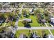 An aerial view of a home with a large grassy yard and mature trees in a quiet neighborhood at 522 Wisconsin Ave, St Cloud, FL 34769