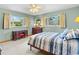 Bedroom with green walls and a blue-striped bed at 522 Wisconsin Ave, St Cloud, FL 34769