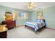 A light green bedroom featuring light carpeting and a dark wood bedroom set at 522 Wisconsin Ave, St Cloud, FL 34769