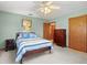 Bedroom with a blue and white quilt, a dresser, and a closet at 522 Wisconsin Ave, St Cloud, FL 34769