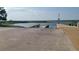 A concrete boat ramp leading into a serene lake with clear skies in the background at 522 Wisconsin Ave, St Cloud, FL 34769