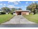 Charming single-story home with a well-manicured front yard and a long driveway at 522 Wisconsin Ave, St Cloud, FL 34769