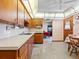 View of an eat-in kitchen featuring wood cabinets and a vintage ceiling light at 522 Wisconsin Ave, St Cloud, FL 34769