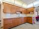 Image shows a kitchen with wood cabinets and a tile backsplash at 522 Wisconsin Ave, St Cloud, FL 34769