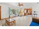 Relaxing living room with neutral walls, a view to the Gathering room, and a large window at 522 Wisconsin Ave, St Cloud, FL 34769