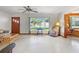 Inviting living room featuring a large window, ceiling fan, and comfortable seating arrangement at 522 Wisconsin Ave, St Cloud, FL 34769