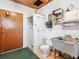 A functional utility room featuring a shower, toilet, sink, and storage cabinets at 522 Wisconsin Ave, St Cloud, FL 34769