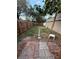 View of the backyard with a small walkway and wooden fence at 5433 Vanderlin St, Orlando, FL 32810