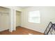 Bright bedroom with wood-look flooring, a closet with folding doors, and window at 549 Hunter Cir, Kissimmee, FL 34758