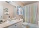 Cozy bathroom featuring a shower with a colorful striped curtain at 5550 E Michigan St # 1210, Orlando, FL 32822