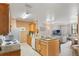 Well-lit kitchen next to the living room, featuring essential appliances and ample counter space at 5550 E Michigan St # 1210, Orlando, FL 32822