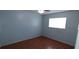 Bedroom with light blue walls and wood-look laminate flooring at 5843 Willow Leaf Ct, Orlando, FL 32807