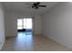 Open living room featuring tile floors and sliding glass door access to screened-in patio at 5843 Willow Leaf Ct, Orlando, FL 32807