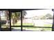 A backyard with a fence and small palm trees is viewed from behind a screen door at 5843 Willow Leaf Ct, Orlando, FL 32807