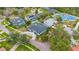 An aerial view of an estate home featuring a paver driveway, dark roof and beautifully manicured landscaping at 6229 Indian Meadow St, Orlando, FL 32819