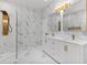 Modern bathroom with dual marble vanities, gold fixtures, and a glass-enclosed shower at 6229 Indian Meadow St, Orlando, FL 32819