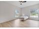 Bedroom featuring light wood flooring, a ceiling fan, and two bright windows for plenty of natural light at 6229 Indian Meadow St, Orlando, FL 32819