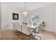 Bright dining room features a modern chandelier, large marble table, and picture window with neighborhood views at 6229 Indian Meadow St, Orlando, FL 32819