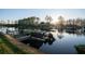 Dock on the water with a covered boat, ready for a lake cruise at sunset at 6229 Indian Meadow St, Orlando, FL 32819