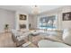 Bright living room featuring a fireplace, modern furniture, and sliding glass doors to the backyard pool at 6229 Indian Meadow St, Orlando, FL 32819