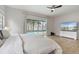 Well-lit bedroom with a view of the pool, ceiling fan, and light wood floor at 6229 Indian Meadow St, Orlando, FL 32819