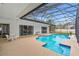 Enclosed swimming pool featuring an outdoor seating area, a serene and screened enclosure, and ample space at 6229 Indian Meadow St, Orlando, FL 32819