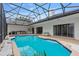 Enclosed pool showcasing its blue tiling, spacious layout, and outdoor seating at 6229 Indian Meadow St, Orlando, FL 32819