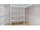 Bright and organized walk-in closet with built-in shelving and wood floors at 6229 Indian Meadow St, Orlando, FL 32819