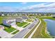 Aerial view of multiple homes within a picturesque Primary-planned community with lakes at 64 Citrine Loop, Kissimmee, FL 34758