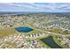 Expansive aerial view of a residential community with lakes and well-spaced homes in the distance at 64 Citrine Loop, Kissimmee, FL 34758