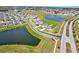 A stunning aerial shot showcases a neighborhood surrounded by scenic lakes and meticulously landscaped grounds at 64 Citrine Loop, Kissimmee, FL 34758