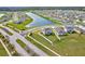 Aerial view of homes in a Primary-planned community with a neighborhood pond at 64 Citrine Loop, Kissimmee, FL 34758