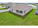 Aerial view of a backyard and patio area with privacy fence at 64 Citrine Loop, Kissimmee, FL 34758