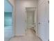 Bright hallway with tile flooring, neutral walls and doors to rooms and bathroom at 64 Citrine Loop, Kissimmee, FL 34758