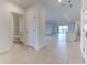 Hallway showcasing modern design with tile flooring leading to various rooms at 64 Citrine Loop, Kissimmee, FL 34758