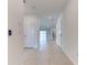 Hallway view showcasing tile flooring, recessed lighting, and doors leading to various rooms in the home at 64 Citrine Loop, Kissimmee, FL 34758