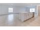 Stylish kitchen island boasts a stainless steel sink and ample white cabinet storage at 64 Citrine Loop, Kissimmee, FL 34758