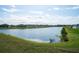 Beautiful serene real estate with lake view of lakeside homes with fenced yards on a bright, sunny day at 64 Citrine Loop, Kissimmee, FL 34758