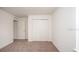 Empty bedroom featuring carpeted floors, a closet with double doors, a white door, and great light at 6627 Lullaby Way, Mascotte, FL 34753