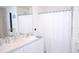 Bright bathroom featuring double sinks, a white shower curtain, and a large mirror at 6910 Se 111Th Pl, Belleview, FL 34420