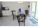 Light-filled dining area with stylish table, seating, and sliding glass door at 6910 Se 111Th Pl, Belleview, FL 34420