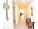 Inviting hallway featuring neutral walls, tile floors, bench seating, and decorative wall art at 6910 Se 111Th Pl, Belleview, FL 34420