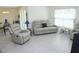 Bright living room featuring comfortable seating, tile floors, and neutral walls at 6910 Se 111Th Pl, Belleview, FL 34420