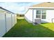 Side yard showcasing the AC unit and a well-maintained lawn at 6910 Se 111Th Pl, Belleview, FL 34420