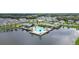 Aerial view of a community pool, pool house and playground surrounded by a tranquil lake and beautiful homes at 704 Hyperion Dr, Debary, FL 32713