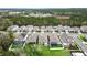 Aerial view of homes featuring backyard patios, green grass, white fencing, and mature trees at 704 Hyperion Dr, Debary, FL 32713