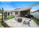 Backyard patio with shade cover, pavers, seating, play area, grill and enclosed porch at 704 Hyperion Dr, Debary, FL 32713